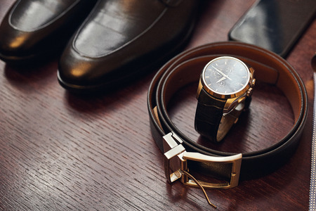 different accessories of a businessman for creating a style of a people lie on a wooden backgroundの写真素材