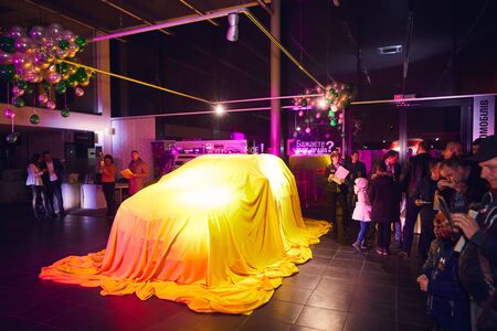 Vinnitsa, Ukraine - March 21, 2018. Renault Kadjar hidden under yellow cover - new model car presentation in showroomのeditorial素材