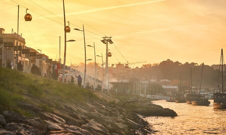09 of December, 2018 - Porto, Portugal: Boats on Douro river with view on  Red roofs of side Villa Nova de Gaia  in Porto. Concept of world travel, sightseeing and tourismのeditorial素材
