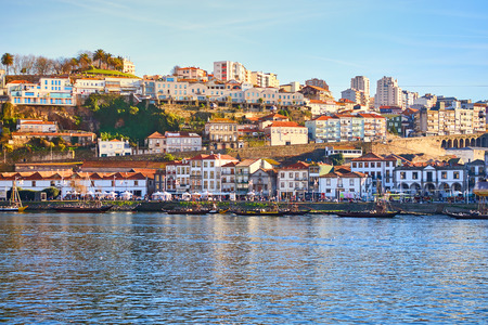 Boats on Douro river with view on  Red roofs of side Villa Nova de Gaia  in Porto. Concept of world travel, sightseeing and tourismの写真素材