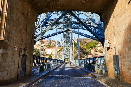 10 of December, 2018 - Porto, Portugal: View of the historic city with the Dom Luiz bridge. A metro train can be seen on the bridgeのeditorial素材