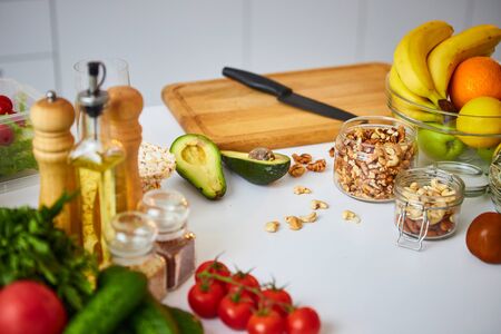 Raw organic vegetables, fruits and nuts with fresh ingredients for healthily cooking on kitchen. Vegan or diet food concept. Healthy Lifestyle and Eatingの写真素材