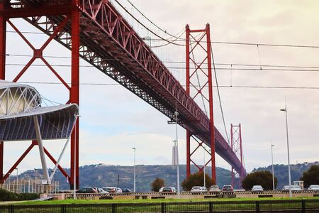 LISBON, PORTUGAL - December 12, 2018:  The 25 April bridge (Ponte 25 de Abril) is a steel suspension...