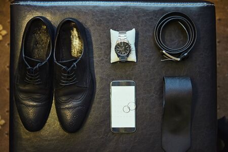 different accessories of a businessman for creating a style of a people lie on a wooden backgroundの写真素材