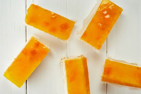 Orange jelly sponge cakes on wooden backgroundの写真素材