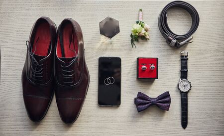 different accessories of a businessman for creating a style of a people lie on a wooden backgroundの写真素材