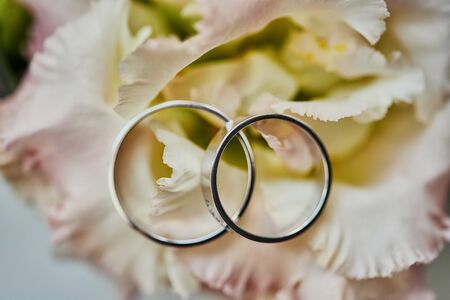 wedding rings lie on the bouquet