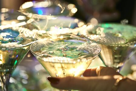 martini glasses in the form of a cascade or pyramid lit light at the wedding party