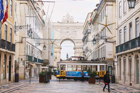 LISBON, PORTUGAL, 14, December, 2018: Wooden historical vintage yellow street tram 28 moving near ...