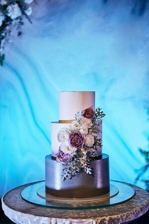 wedding festive multi-storey cake in white tone decorated with beautiful flowersの写真素材