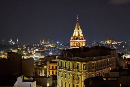 Galata Kulesi Tower at night in Istanbul, Turkey. Ancient Turkish famous landmark in Beyoglu district, European side of the city. Architecture of the former Constantinople.A historical place  made by Genoeseの写真素材