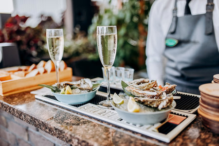 Fresh open oysters with a glass of chilled prosecco wine served on table. Seafood deliciosの写真素材