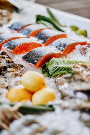 Chilled steaks of red fish. Pieces of fish lie on ice. Freezer shop windowの写真素材