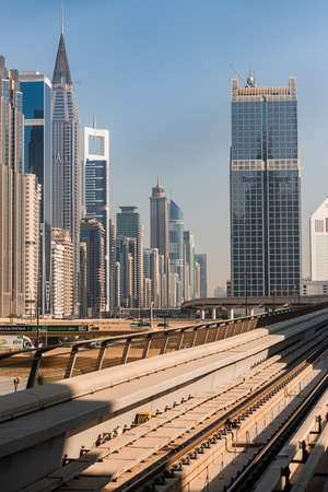 Dubai, United Arab Emirates - November 06, 2021: Dubai metro at background of skyscrapers. A view of...