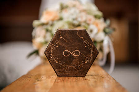 wedding rings lie on a beautiful box near bridal bouquet