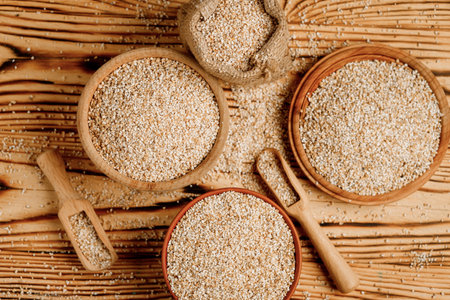 Barley groats in bowls and bags on a wooden background. High quality photo