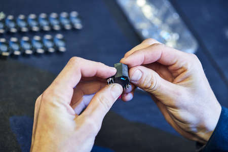 The master specialist makes electromagnetic coils for computer devices