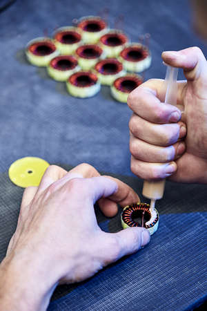 The master specialist makes electromagnetic coils for computer devicesのeditorial素材