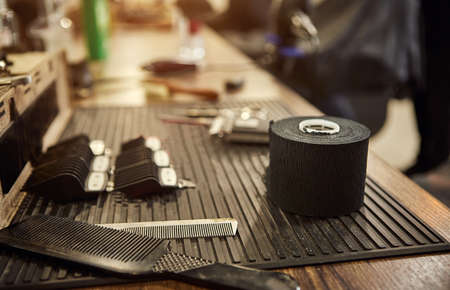 Barber shops tools. Accessories for cutting on the table in a barbershop. Comb, brush, scissors,...