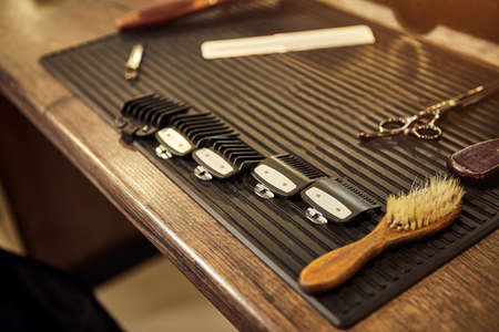 Barber shops tools. Accessories for cutting on the table in a barbershop. Comb, brush, scissors,...