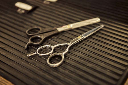 Barber shops tools. Scissors for cutting lying on the table in a barbershop