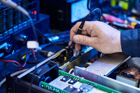 Repairing Hardware Equipment. Repair Shop and Worker with Tools.  Microchip and Circuit Board....