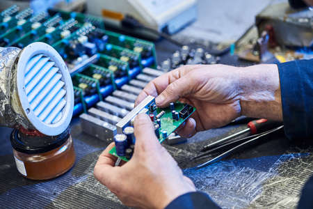 Repairing Hardware Equipment. Repair Shop and Worker with Tools.  Microchip and Circuit Board....