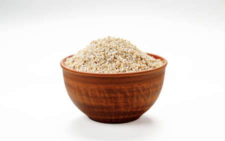 Barley groats in bowls and bags isolated on a white background. High quality photoの写真素材