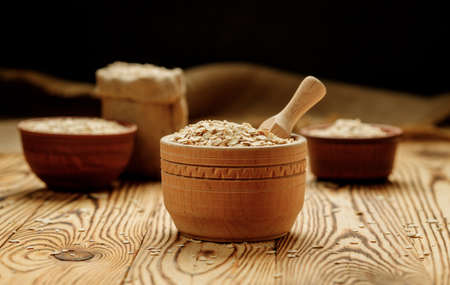 Ðžatmeal in bowls and bags on a wooden background. High quality photo