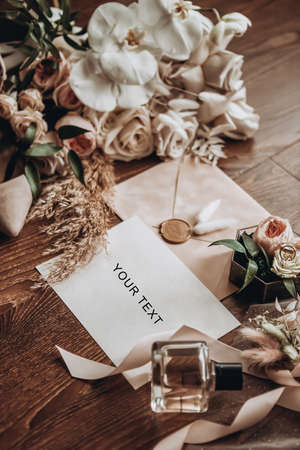bridal accessories such as shoes, bouquet , ring and perfume lie on a tableの写真素材