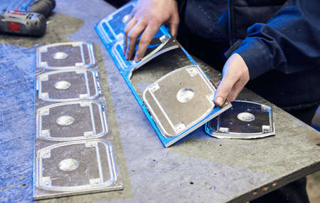 Ð¡raftsman disassembles aluminum blanks of metal profile. Steel industry. Cutting aluminium...