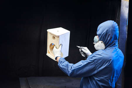 Professional painter works in the paint shop