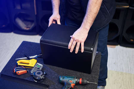 Worker is production speakers and loudspeakers at the factory. Handmade creation of acoustic music systemsの写真素材