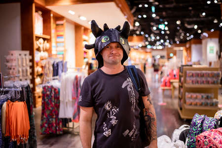 DUBAI; UNITED ARAB EMIRATES - November 05; 2021: Man tourist at the souvenirs shop in Dubai Park and Resortのeditorial素材