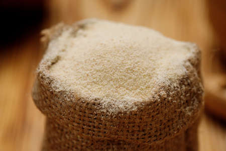 Semolina in bowls and bags on a wooden background. High quality photoの写真素材