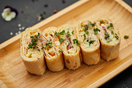 Snacks of pita bread with cheese and tomatoes. Variety mix of small sandwiches on dark background....