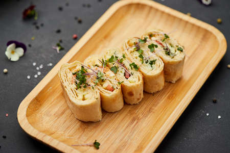 Snacks of pita bread with cheese and tomatoes. Variety mix of small sandwiches on dark background. Photo for restaurant menuの写真素材