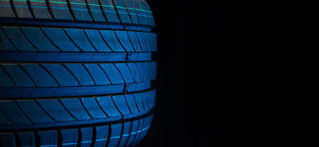 New car tires. Group of road wheels on dark background. Summer Tires with asymmetric tread design. Driving car concept. Close-upの写真素材
