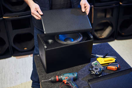 Worker is production speakers and loudspeakers at the factory. Handmade creation of acoustic music...