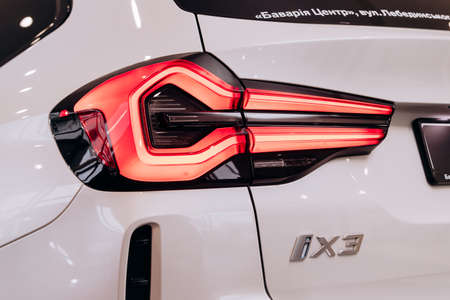 Vinnitsa, Ukraine - January 14, 2022. BMW IX 3 - new model all-electric SUV car presentation in showroom - rear headlightのeditorial素材