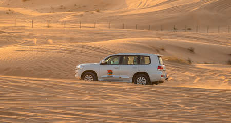 11 November 2021, UAE, Dubai: Desert Safari along the sand dunes in Dubai or Abu Dhabi, UAE - traditional entertainment for touristsのeditorial素材