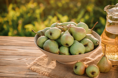 Fresh ripe pear in the basket on wooden table with natural orchard background on sunset. Vegetarian fruit composition. Harvesting conceptの写真素材
