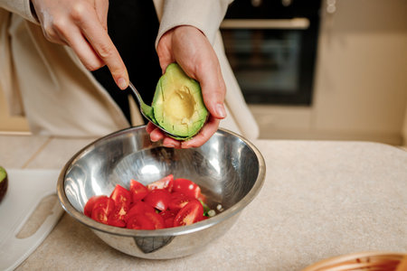 Female hands cooking with avocado at table in home kitchen. Nutrition And Diet. Healthy food concept. Ingredients for saladの写真素材