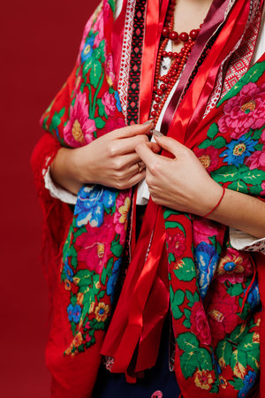 Close up of ukrainian woman in traditional ethnic clothing on viva magenta studio background....