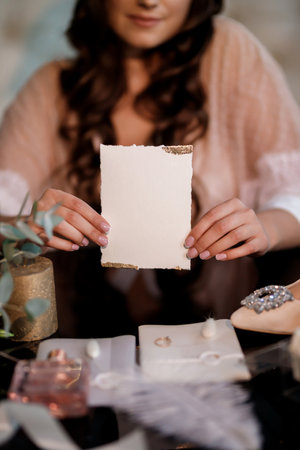 Woman with a wedding invitation card mockup. Invitation, package and letterの写真素材