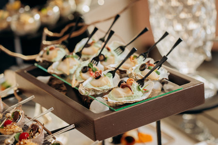 Assortment of delicious snacks on the open buffet festive table in restaurant. Catering plateの写真素材