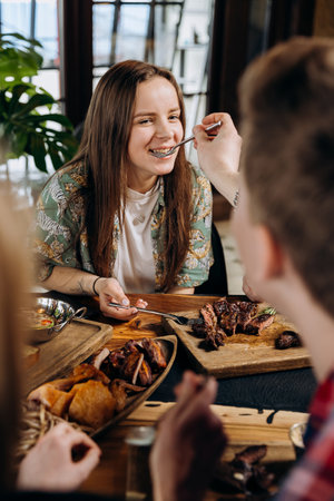 Happy friends having dinner party in pub restaurant. Friendship and youth culture conceptの写真素材