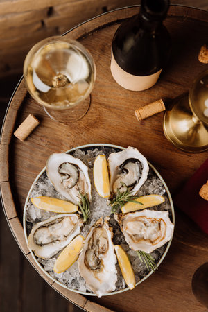 Elegant oysters on ice with lemon and white wine, perfect for gourmet dining and special occasionsの写真素材