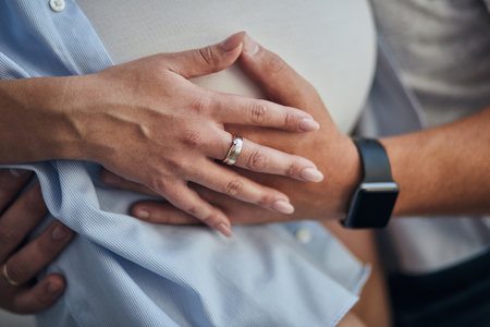 Close up of pregnant couple hugging woman belly. Famiy waiting for a newborn baby