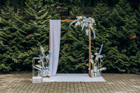 Elegant outdoor wedding arch with floral decorations for a romantic garden ceremonyの写真素材